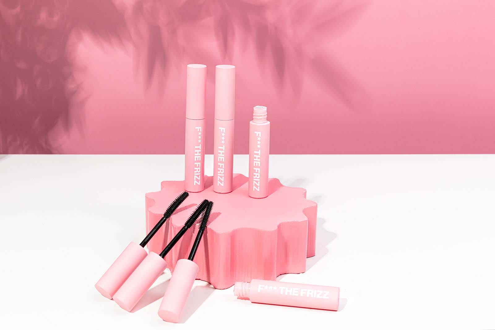 Simple Pink Product Photos with shadows for Anit Frizz Hair Wand. Styled content creation by Megzie Makes