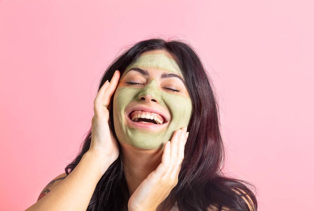 Fun pink model photos for a clay mask brand. Styled product photos by Megzie Makes