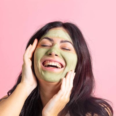 Fun pink model photos for a clay mask brand. Styled product photos by Megzie Makes