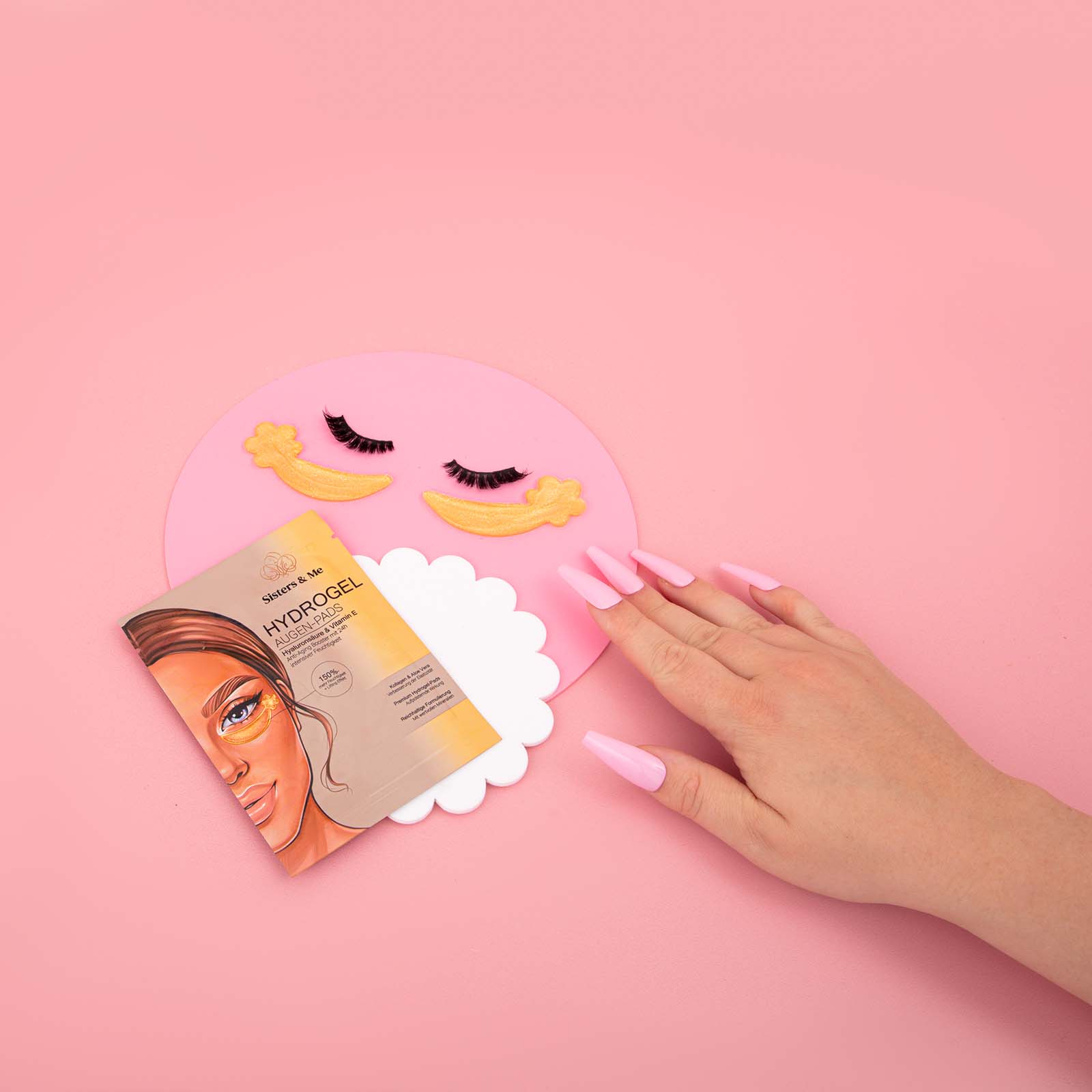 cute pink minimal product photos for face mask brand sisters and me. Styled product stills with a hand by colourpop studio
